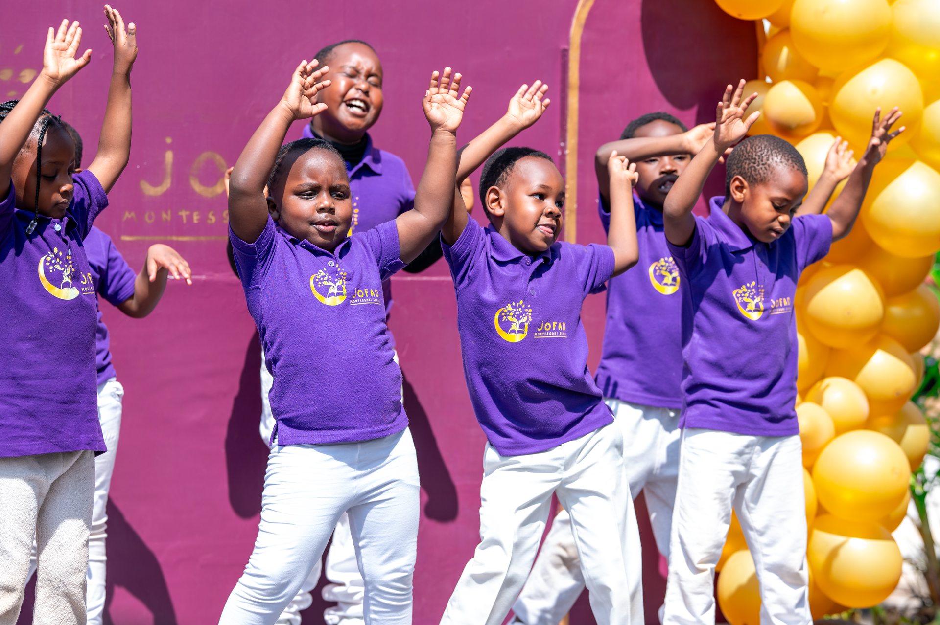 Jofad students dancing joyfully on stage